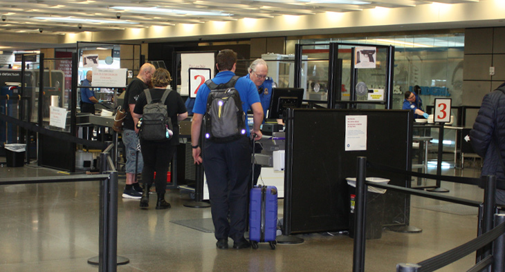 traveler going through TSA checkpoint at airport