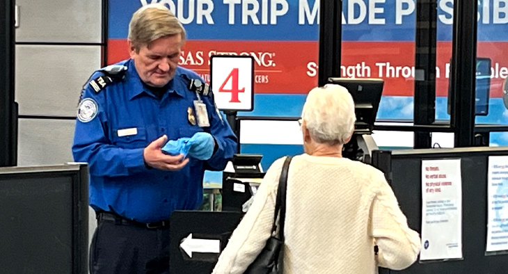 traveler going through TSA checkpoint at airport